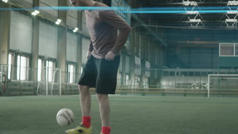 Sportsman-Juggling-Soccer-Ball-on-Indoor-Field